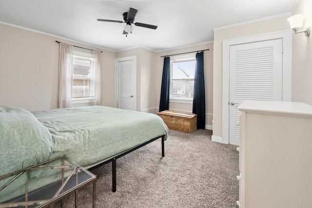 carpeted bedroom with ceiling fan, ornamental molding, and baseboards