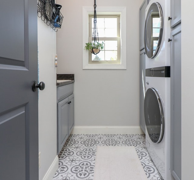 122 Woodside Blvd, Lexington, OH 44904 - clothes washing area with cabinet space, stacked washer / dryer, and baseboards