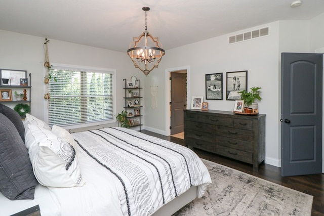 122 Woodside Blvd, Lexington, OH 44904 - bedroom featuring a chandelier, wood finished floors, and baseboards