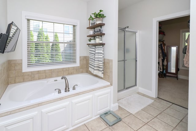 122 Woodside Blvd, Lexington, OH 44904 - bathroom featuring a shower stall, a bath, tile patterned flooring, and baseboards