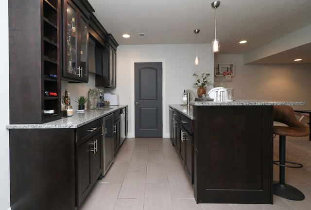 122 Woodside Blvd, Lexington, OH 44904 - kitchen featuring a breakfast bar area, glass insert cabinets, light stone counters, light tile patterned floors, and recessed lighting