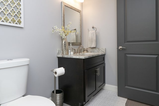122 Woodside Blvd, Lexington, OH 44904 - half bathroom featuring toilet, vanity, and baseboards