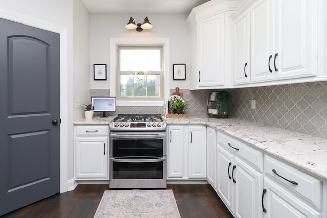 122 Woodside Blvd, Lexington, OH 44904 - kitchen with double oven range, backsplash, dark wood-type flooring, white cabinetry, and light stone countertops