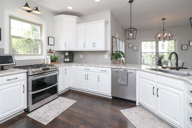 122 Woodside Blvd, Lexington, OH 44904 - kitchen featuring stainless steel appliances, a sink, plenty of natural light, backsplash, and recessed lighting