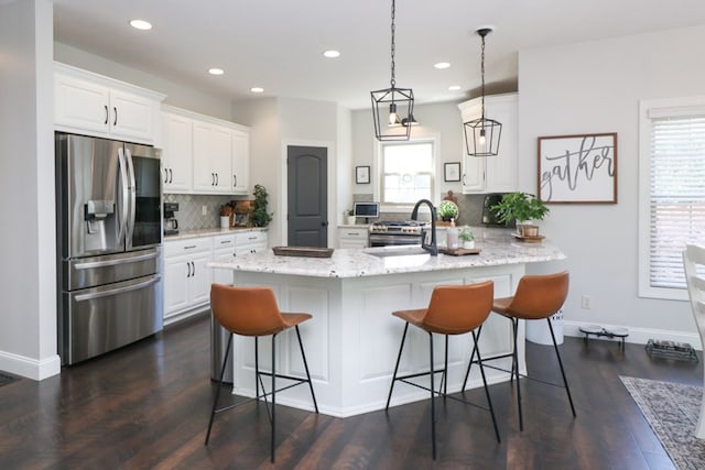 122 Woodside Blvd, Lexington, OH 44904 - kitchen with stainless steel fridge, tasteful backsplash, a kitchen breakfast bar, white cabinets, and a peninsula