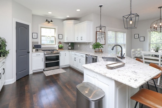 122 Woodside Blvd, Lexington, OH 44904 - kitchen with a sink, stainless steel appliances, a peninsula, healthy amount of natural light, and recessed lighting