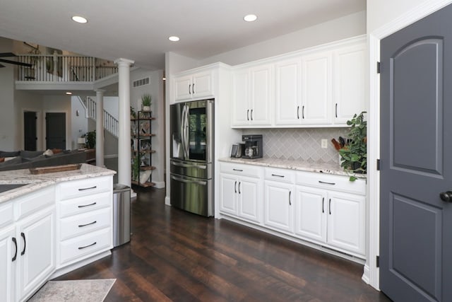 122 Woodside Blvd, Lexington, OH 44904 - kitchen featuring stainless steel refrigerator with ice dispenser, ornate columns, decorative backsplash, light stone countertops, and white cabinets