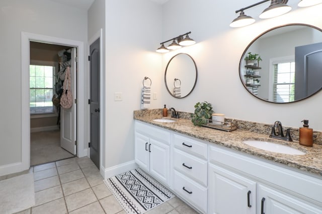 122 Woodside Blvd, Lexington, OH 44904 - bathroom with healthy amount of natural light, double vanity, tile patterned floors, and baseboards