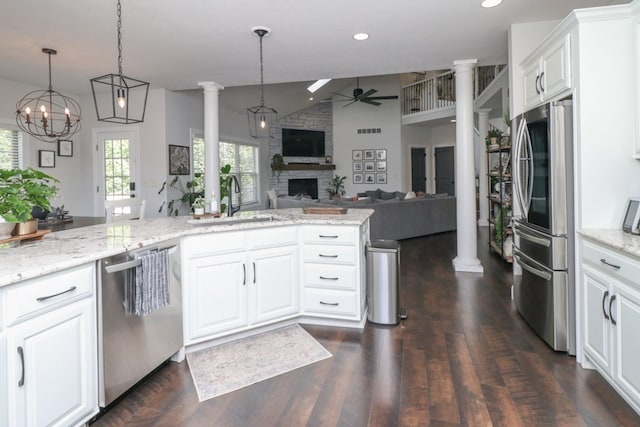122 Woodside Blvd, Lexington, OH 44904 - kitchen featuring stainless steel appliances, ceiling fan, decorative columns, a sink, and a fireplace