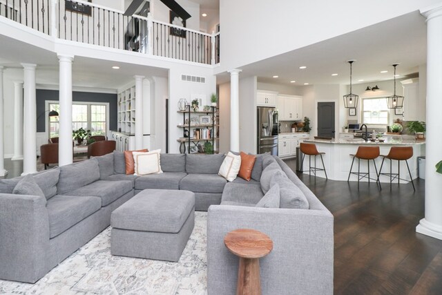 122 Woodside Blvd, Lexington, OH 44904 - living area with decorative columns, healthy amount of natural light, dark wood finished floors, recessed lighting, and a high ceiling