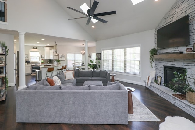 122 Woodside Blvd, Lexington, OH 44904 - living room with high vaulted ceiling, a stone fireplace, a ceiling fan, baseboards, and dark wood-style flooring