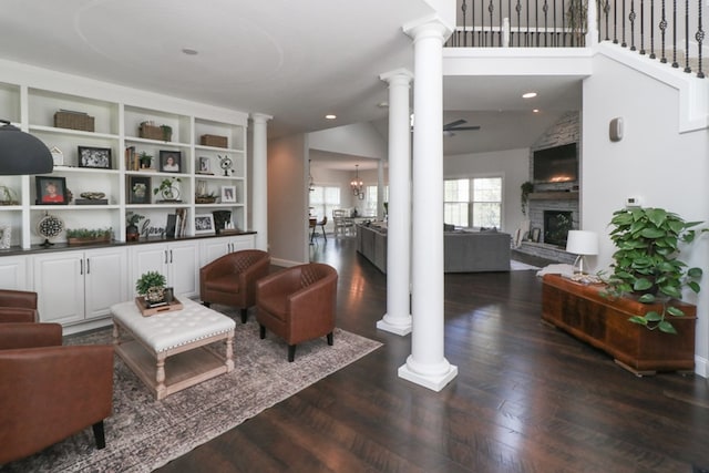 122 Woodside Blvd, Lexington, OH 44904 - living room with decorative columns, a fireplace, dark wood-style flooring, a ceiling fan, and lofted ceiling