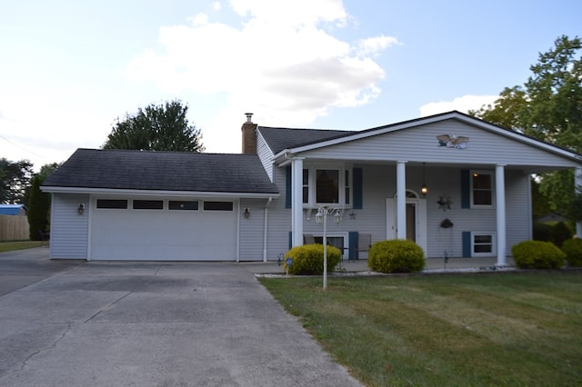 view of front of house featuring covered porch, a garage, and a front lawn