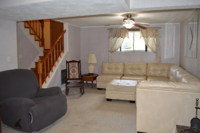 living room with ceiling fan, light colored carpet, and a textured ceiling