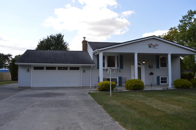 view of front of house featuring covered porch, a garage, and a front lawn