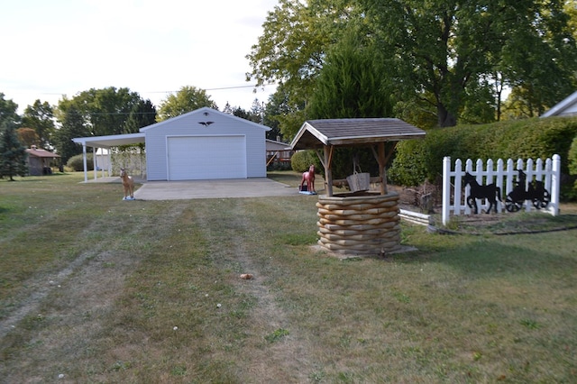 view of yard with an outbuilding, a garage, and a carport