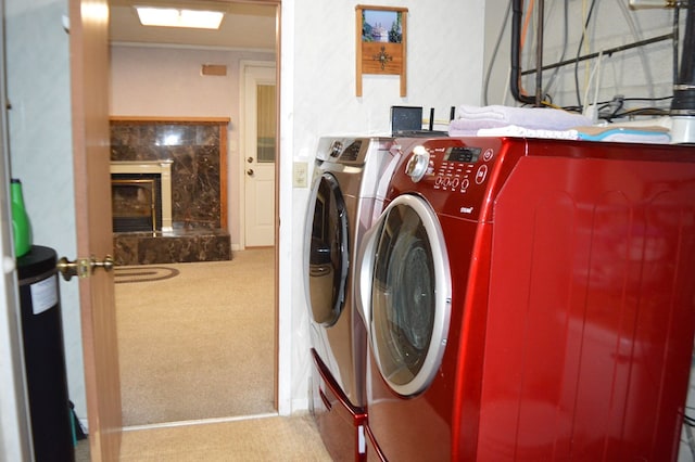 laundry room with independent washer and dryer and light carpet