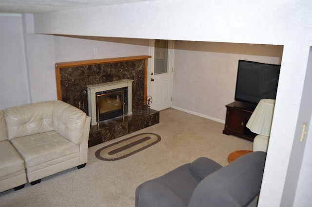 living room featuring a premium fireplace and light carpet