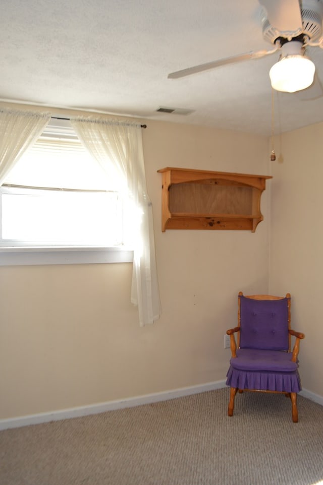 unfurnished room featuring carpet flooring, ceiling fan, and a healthy amount of sunlight