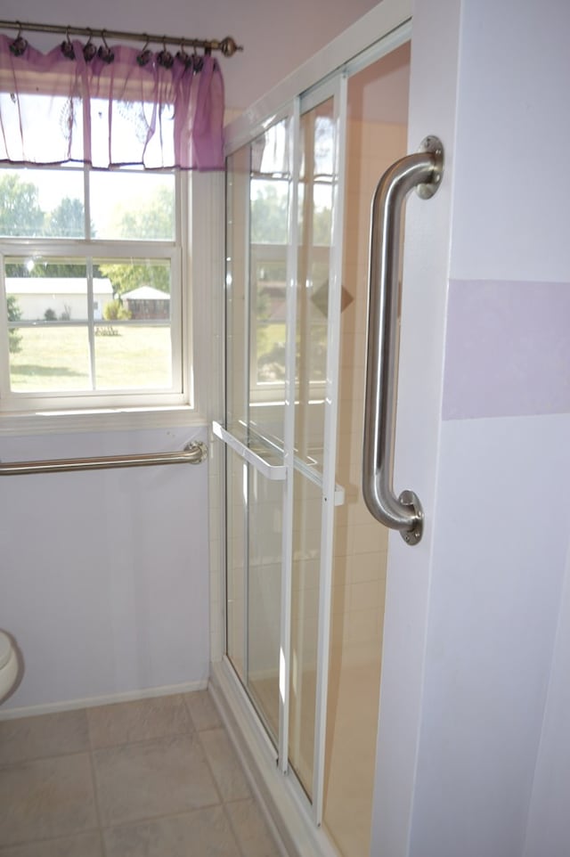 bathroom featuring tile patterned flooring and a shower with shower door