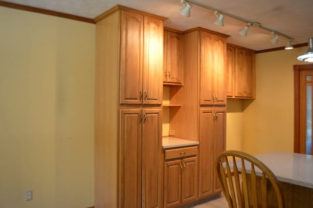 kitchen featuring a textured ceiling and crown molding