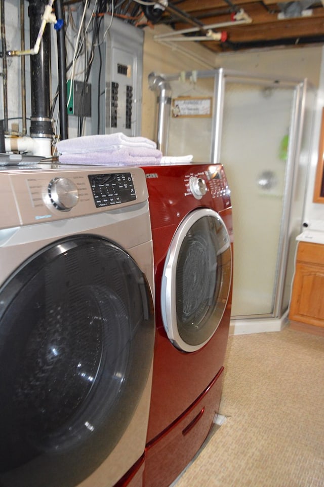 clothes washing area with washer and clothes dryer