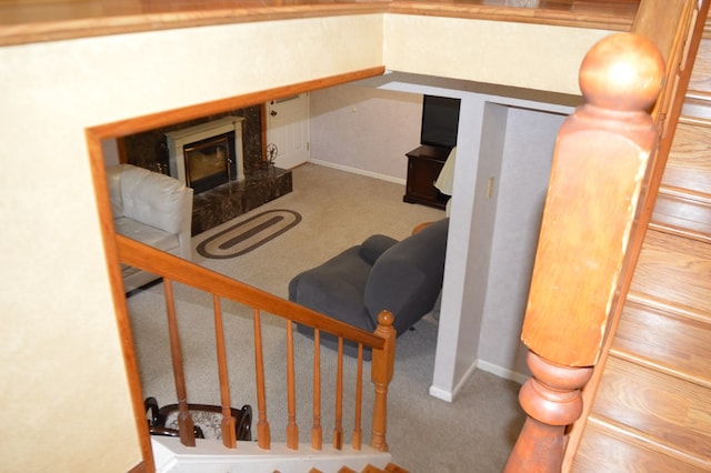 stairs with a high end fireplace and carpet