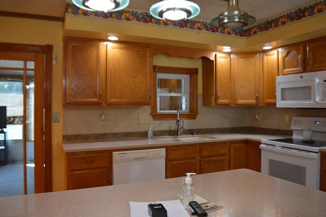 kitchen featuring white appliances, tasteful backsplash, and sink