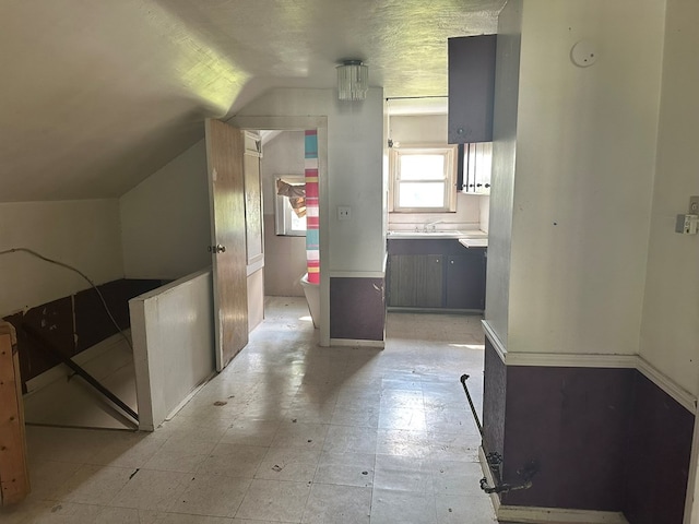 318 S Washington St, Galion, OH 44833 - hallway with lofted ceiling, light flooring, and a sink