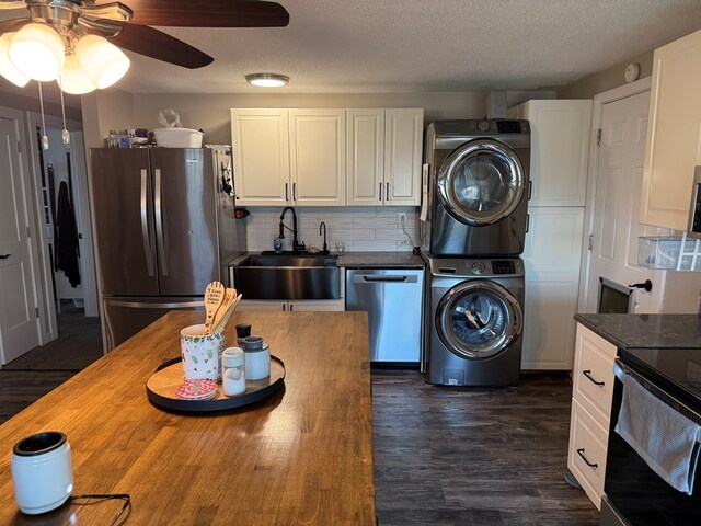 1421 Cullen Ave, Bucyrus, OH 44820 - kitchen featuring stacked washer and dryer, stainless steel appliances, wooden counters, ceiling fan, and a sink