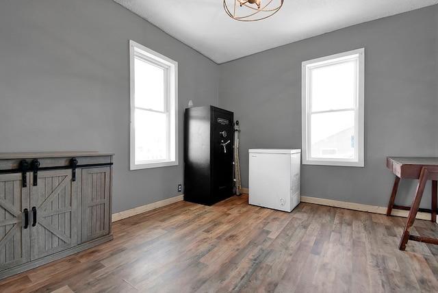 interior space with baseboards and wood finished floors