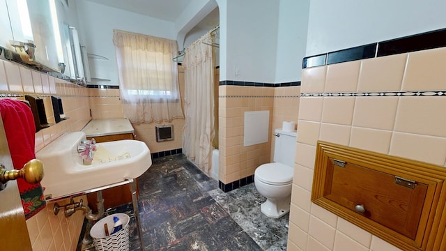 120 S Trimble Rd, Mansfield, OH 44906 - full bathroom with tile walls, toilet, wainscoting, shower / bath combo, and tile patterned floors