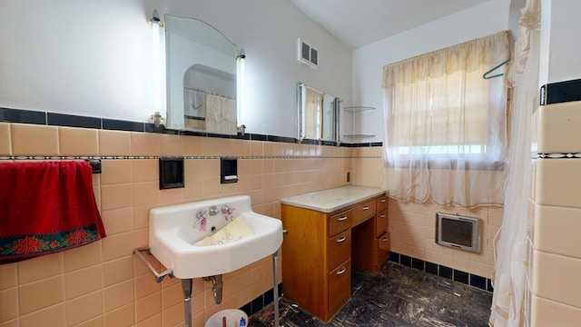 120 S Trimble Rd, Mansfield, OH 44906 - full bathroom featuring tile walls, a sink, and wainscoting