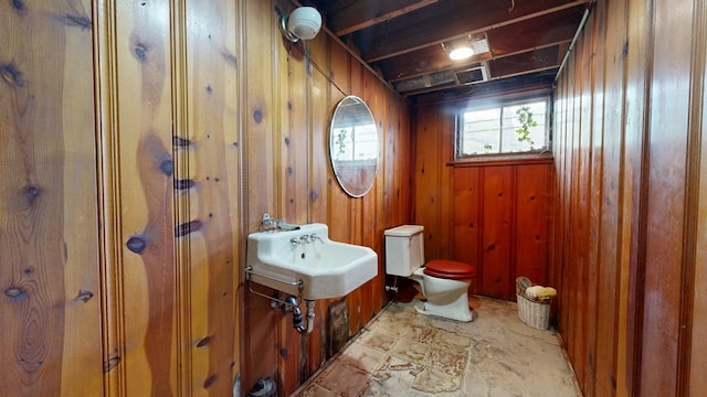 120 S Trimble Rd, Mansfield, OH 44906 - bathroom featuring a sink, toilet, and wood walls