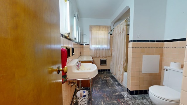 120 S Trimble Rd, Mansfield, OH 44906 - full bath featuring tile walls, toilet, a sink, shower / bath combo, and a wainscoted wall