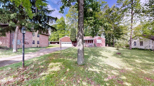 120 S Trimble Rd, Mansfield, OH 44906 - view of front of home with asphalt driveway, a front yard, and brick siding