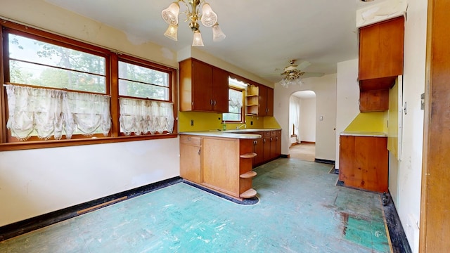 120 S Trimble Rd, Mansfield, OH 44906 - kitchen featuring a peninsula, baseboards, arched walkways, and open shelves