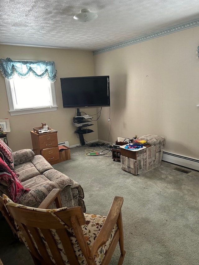 carpeted living room with baseboard heating and a textured ceiling