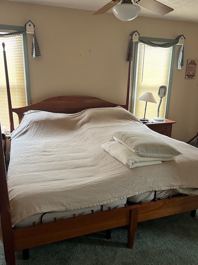 bedroom with ceiling fan and carpet