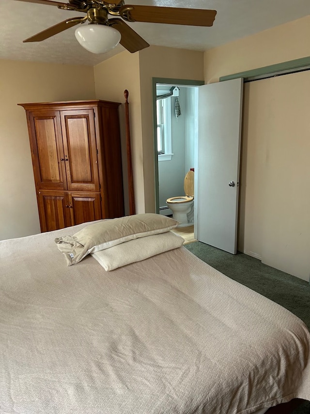 bedroom with ceiling fan, ensuite bath, a baseboard heating unit, and carpet floors