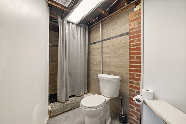 bathroom with toilet and walk in shower