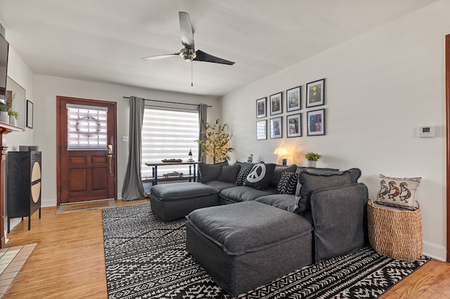 living room with hardwood / wood-style flooring and ceiling fan