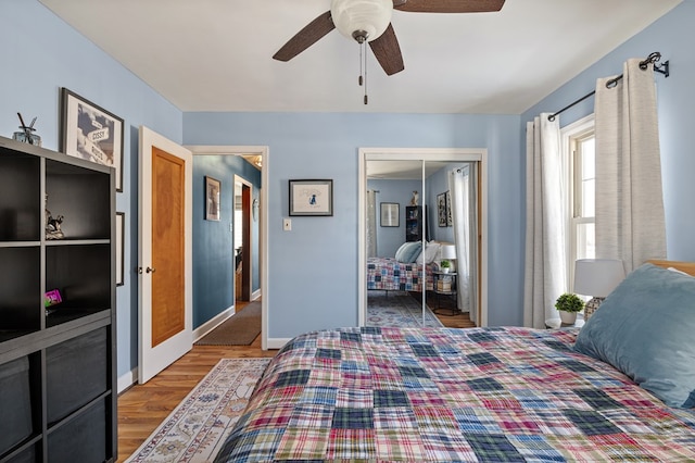 bedroom featuring ceiling fan, hardwood / wood-style floors, and a closet