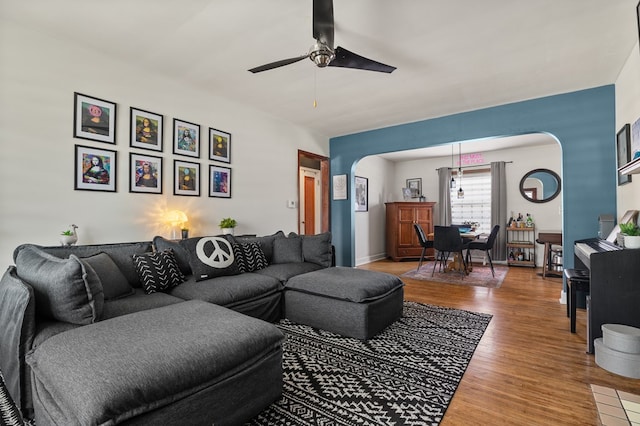 living room featuring ceiling fan and hardwood / wood-style flooring