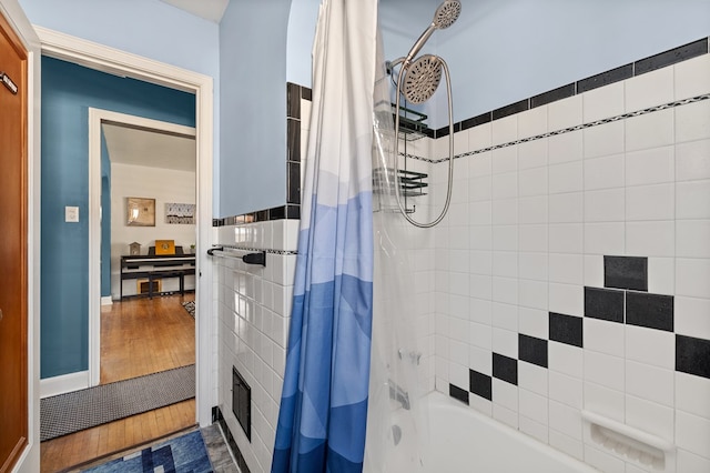 bathroom featuring shower / bath combination with curtain and hardwood / wood-style floors