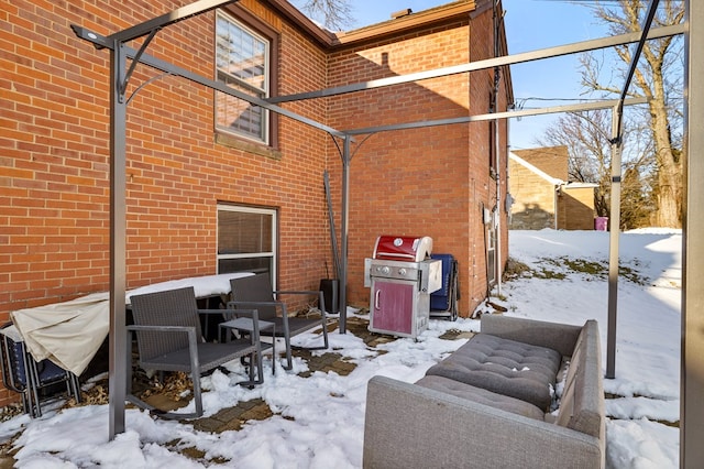 snow covered patio with grilling area