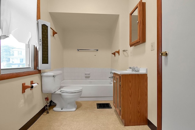 bathroom featuring a bathtub, vanity, and toilet