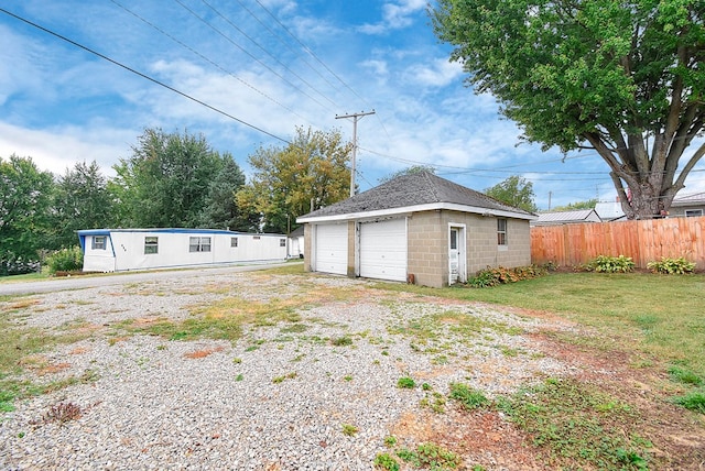 garage featuring a lawn