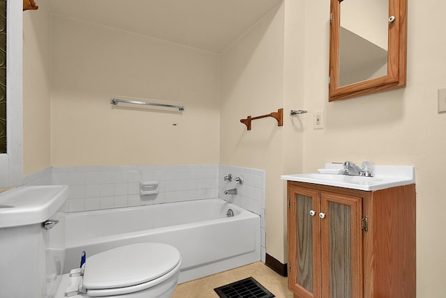 bathroom featuring tile patterned floors, a bathing tub, vanity, and toilet