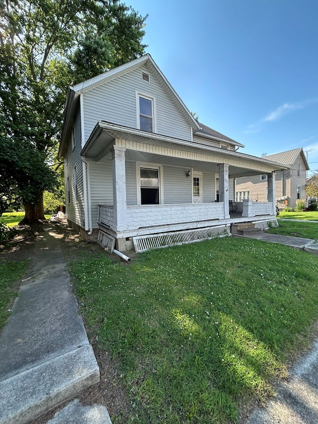 1221 N Sandusky Ave, Bucyrus, OH 44820 - view of front of property with covered porch and a front lawn